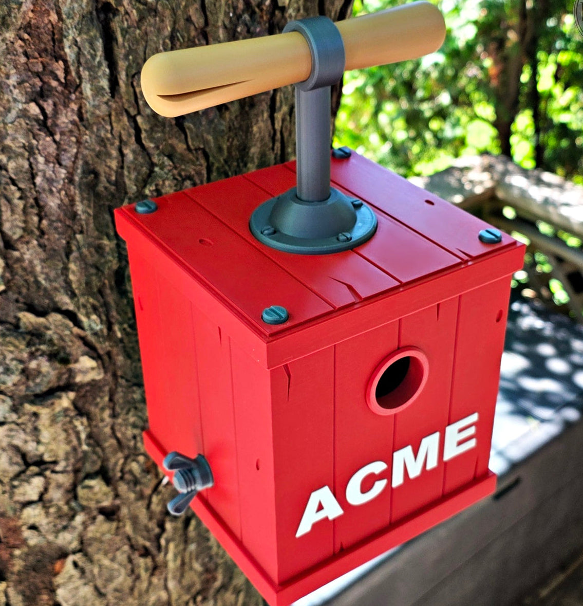 Red birdhouse with 'ACME' branding attached to a tree