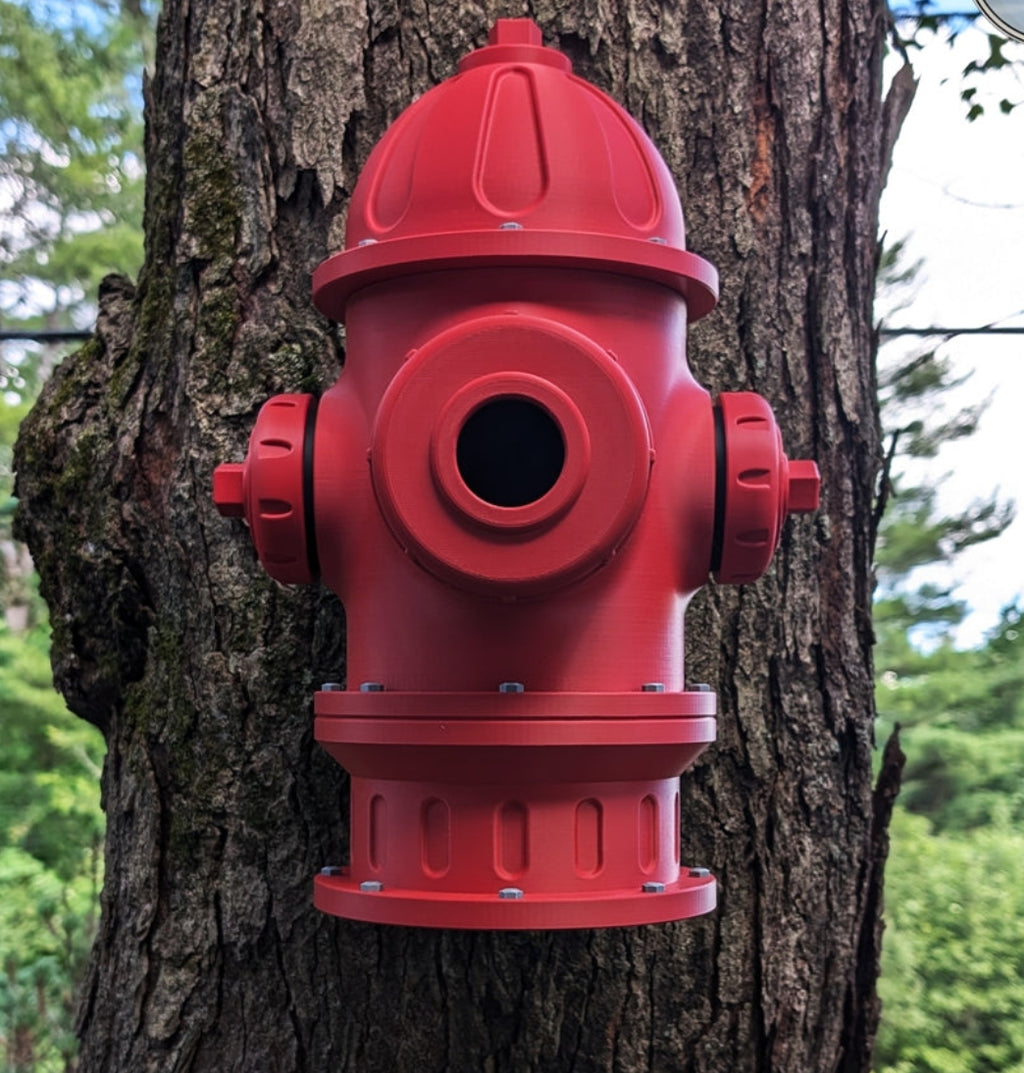 direct front view of the red Fire hydrant birdhouse mounted to a tree