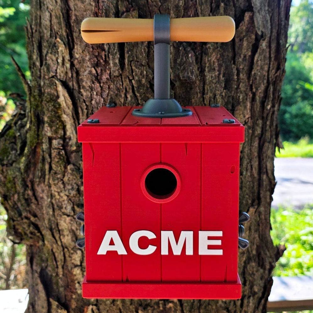 Red birdhouse with 'ACME' branding attached to a tree