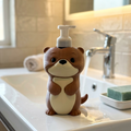 Cute 3D printed Otter soap bottle holder sitting beside a bathroom sink.