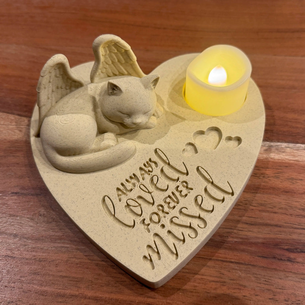 Heart-shaped memorial featuring a British shorthair cat with Angel wings and engraved text on a wooden surface