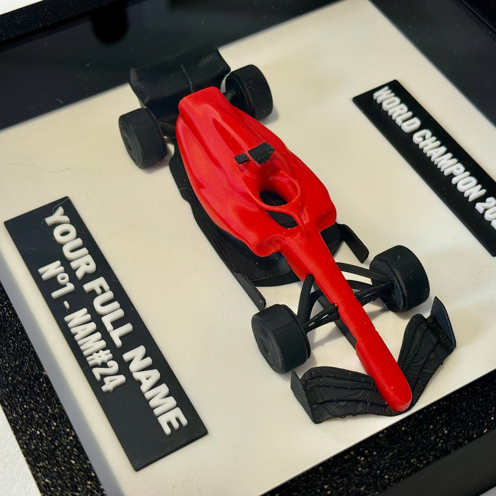 Red and black Formula 1 car model on a display stand with customizable text