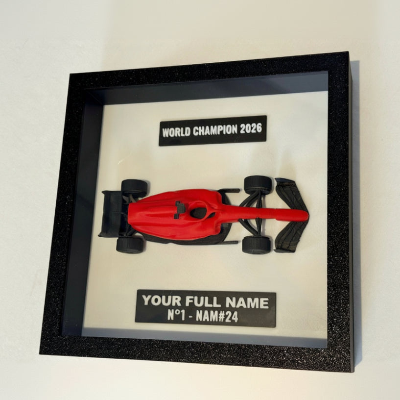 Framed red toy Formula 1 car with 'World Champion 2026' and customizable text on a white background