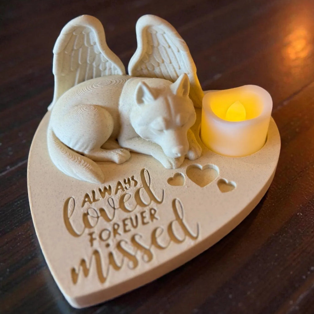 Memorial ornament with a Husky with Angel wings  on a heart-shaped base, featuring a small candle.