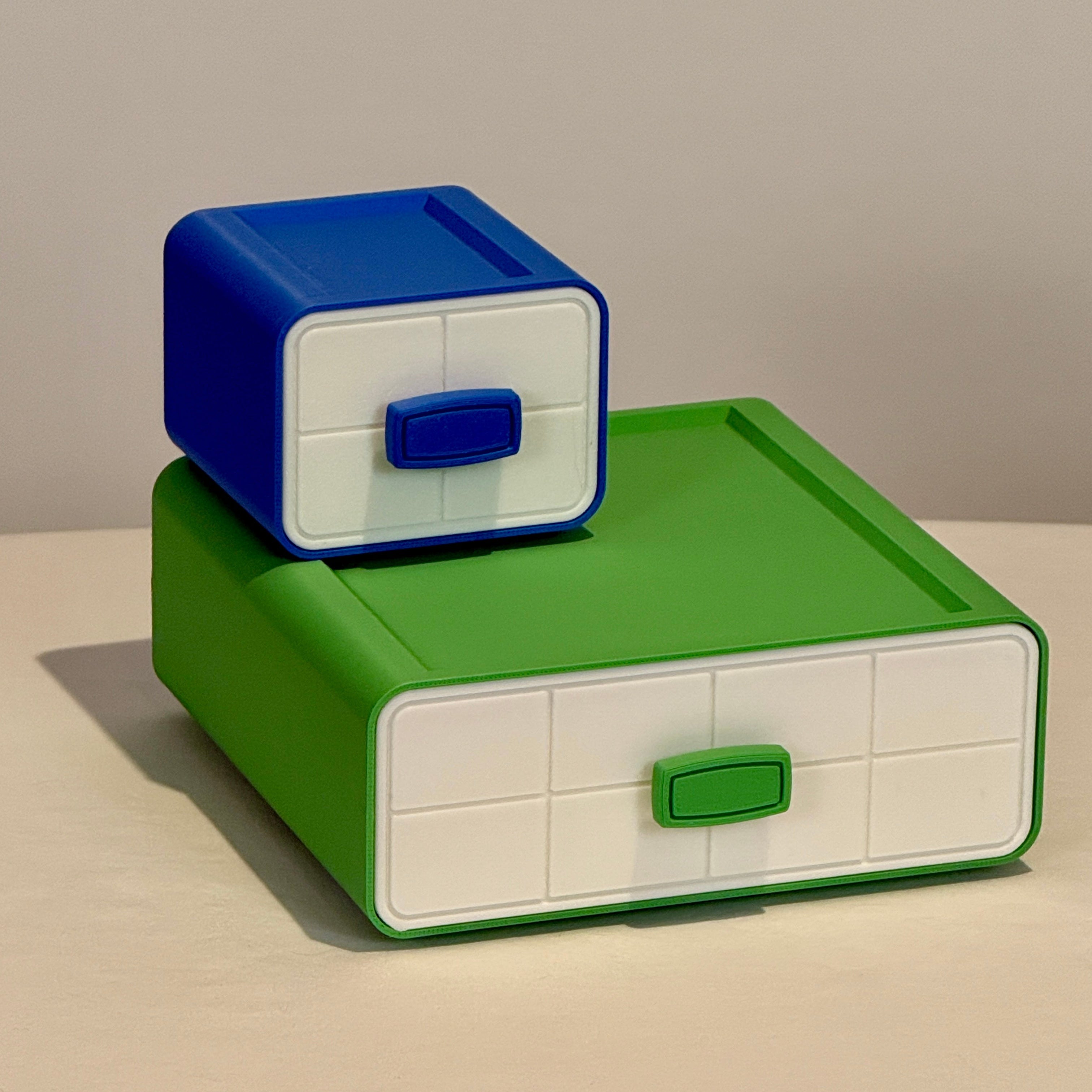 Green and blue storage boxes on a neutral background