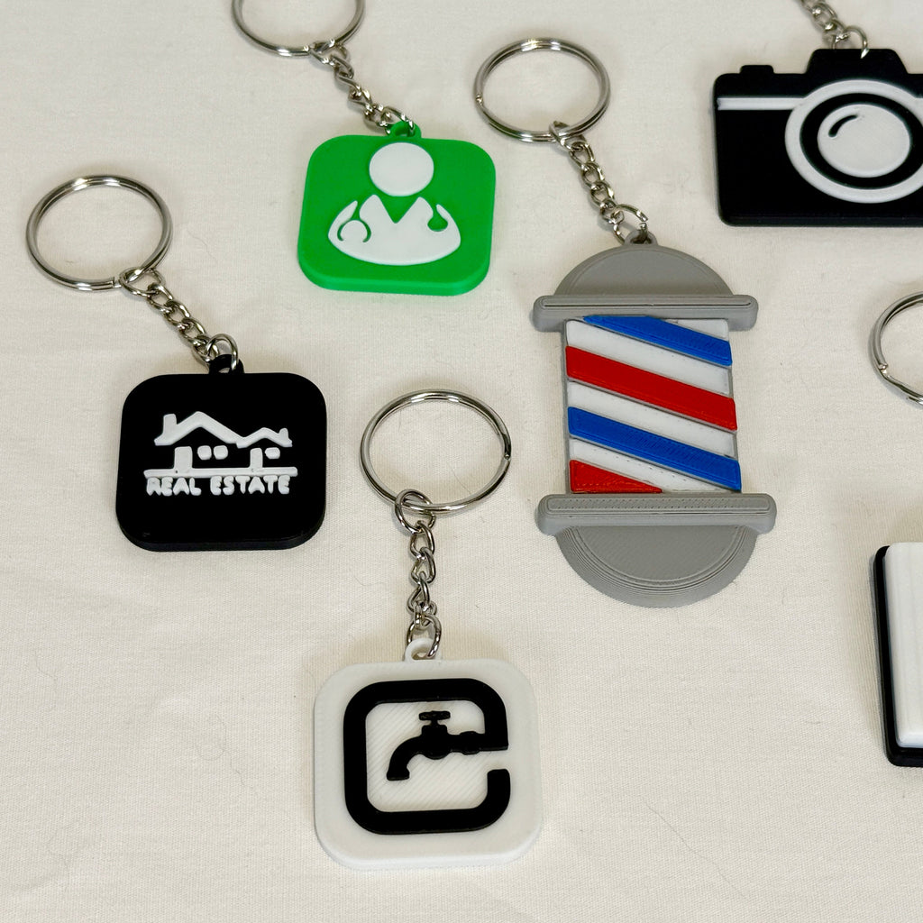 Collection of various keychains with different symbols on a white background