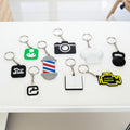 Collection of various keychains with different shapes and designs on a white background