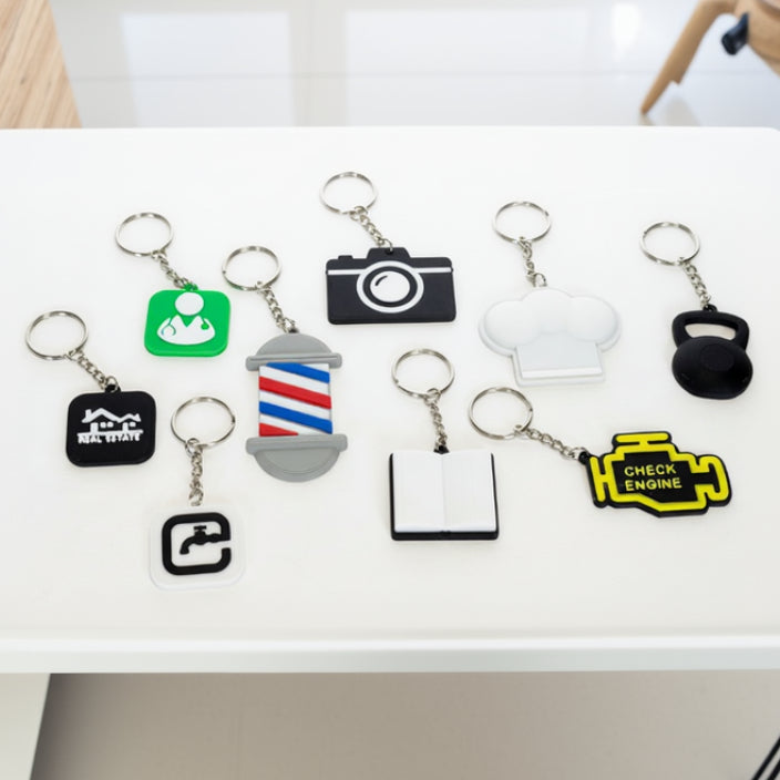 Collection of various keychains with different shapes and designs on a white background