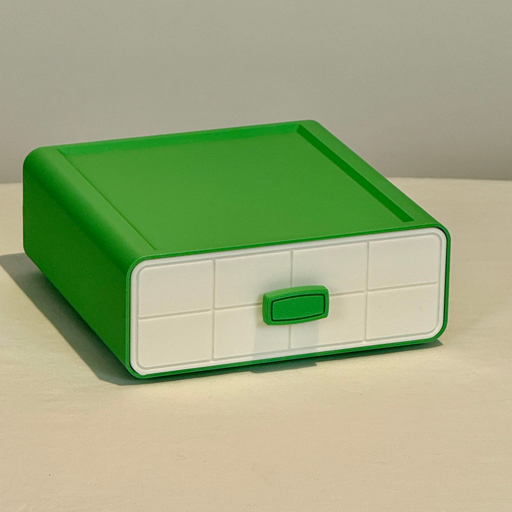 Green and white storage box on a neutral background