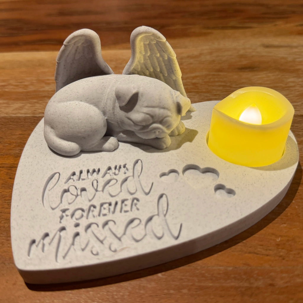 Memorial featuring a pug with Angel wings and 'Always Loved Forever Missed' text on a wooden surface.