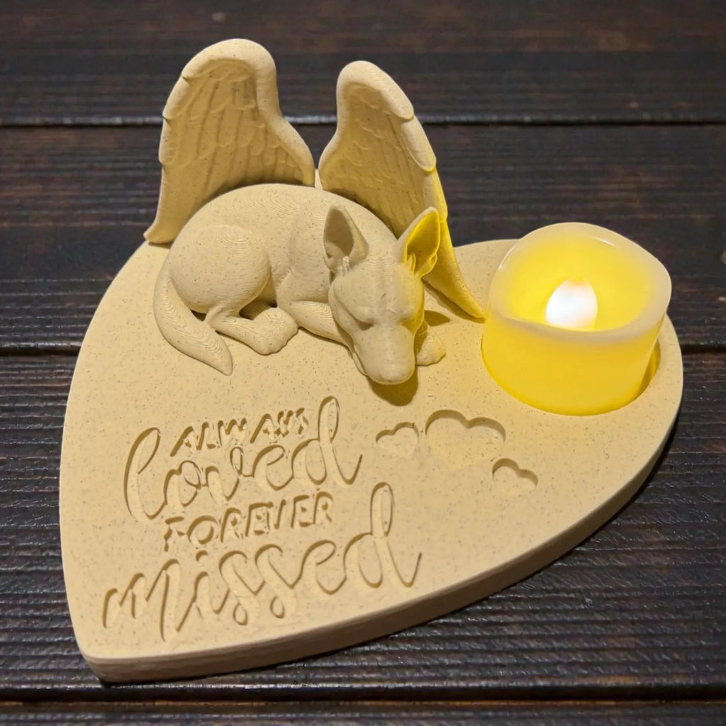 Memorial plaque with shepherd with Angel wings design and 'Always Loved Forever Missed' text on a wooden surface.