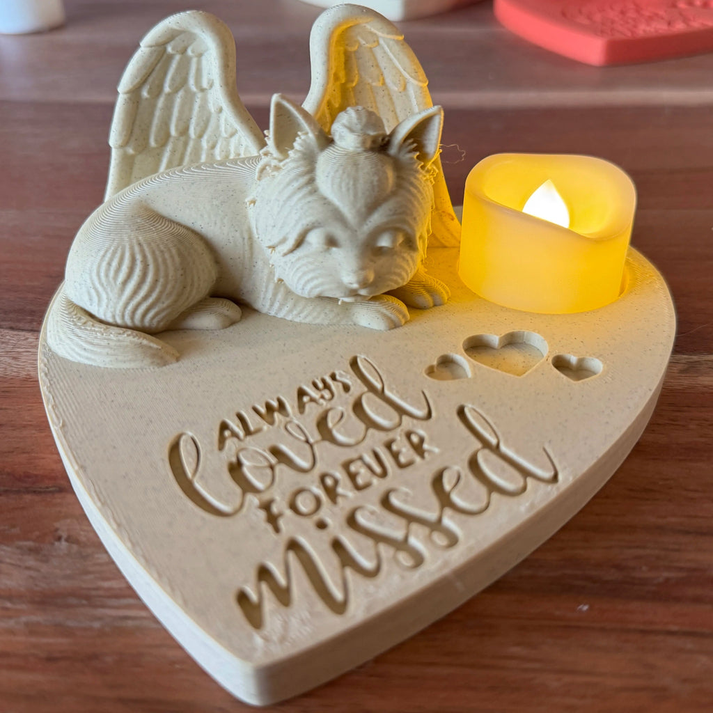 Heart-shaped memorial with a Yorkshire terrier with Angel Wings and a candle, engraved with 'Always Loved Forever Missed', on a wooden surface.