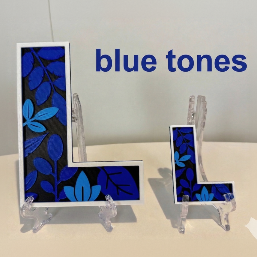 Decorative letter 'L' with blue leaf pattern on a stand, labeled 'blue tones'.