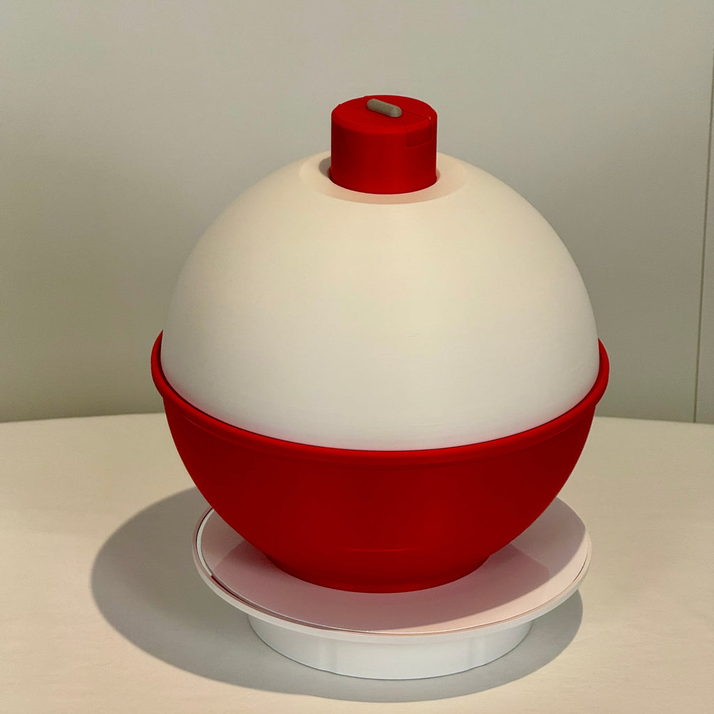Red and white object on a light gray surface with a neutral background