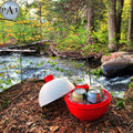 Red cooler with drinks by a stream in a forest
