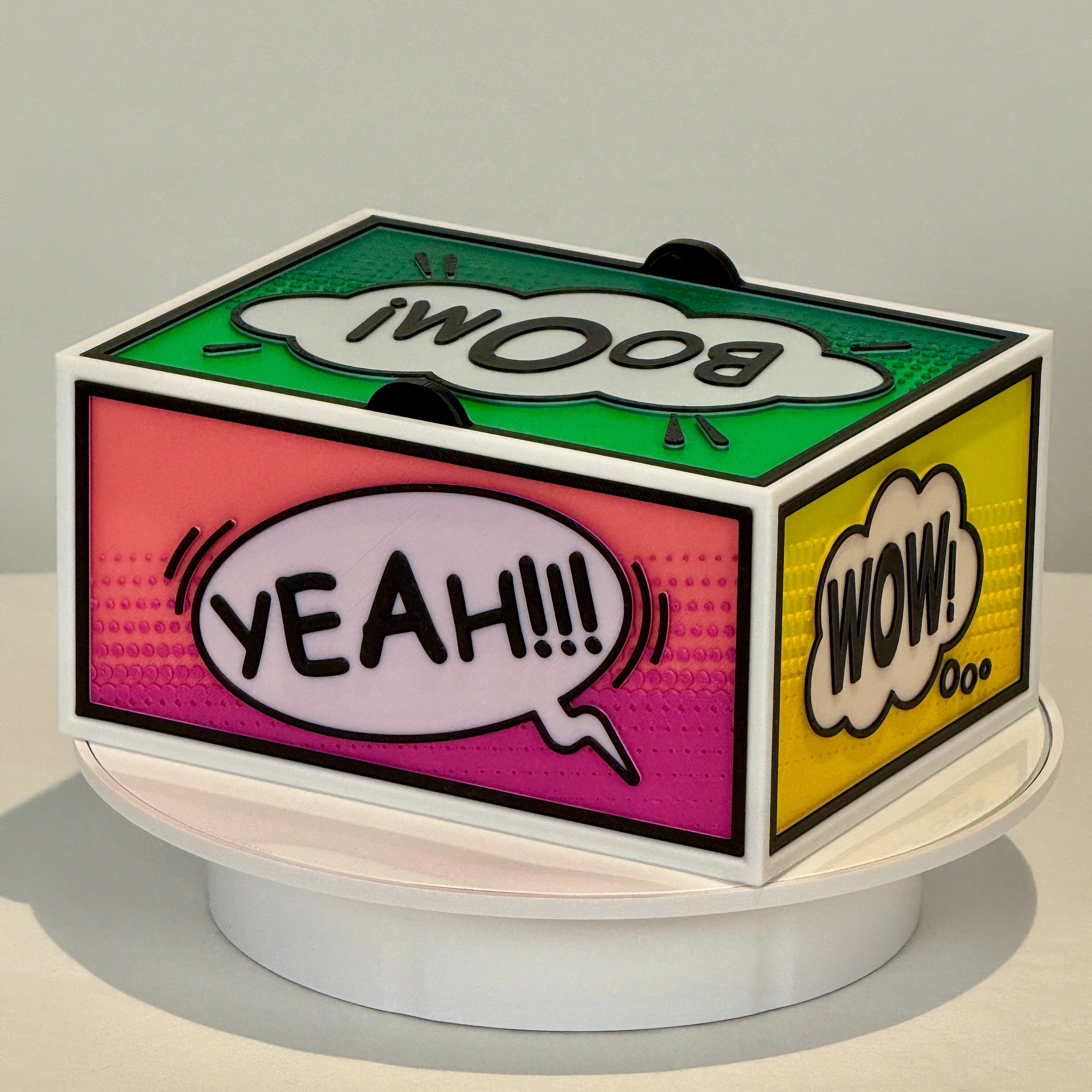 Colorful pop-up phone stand with speech bubble designs on a gray background