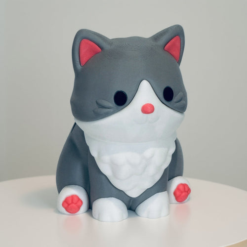 Gray cat-shaped figurine with pink accents on a white background