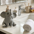 grey elephant soap bottle holder beside a sink