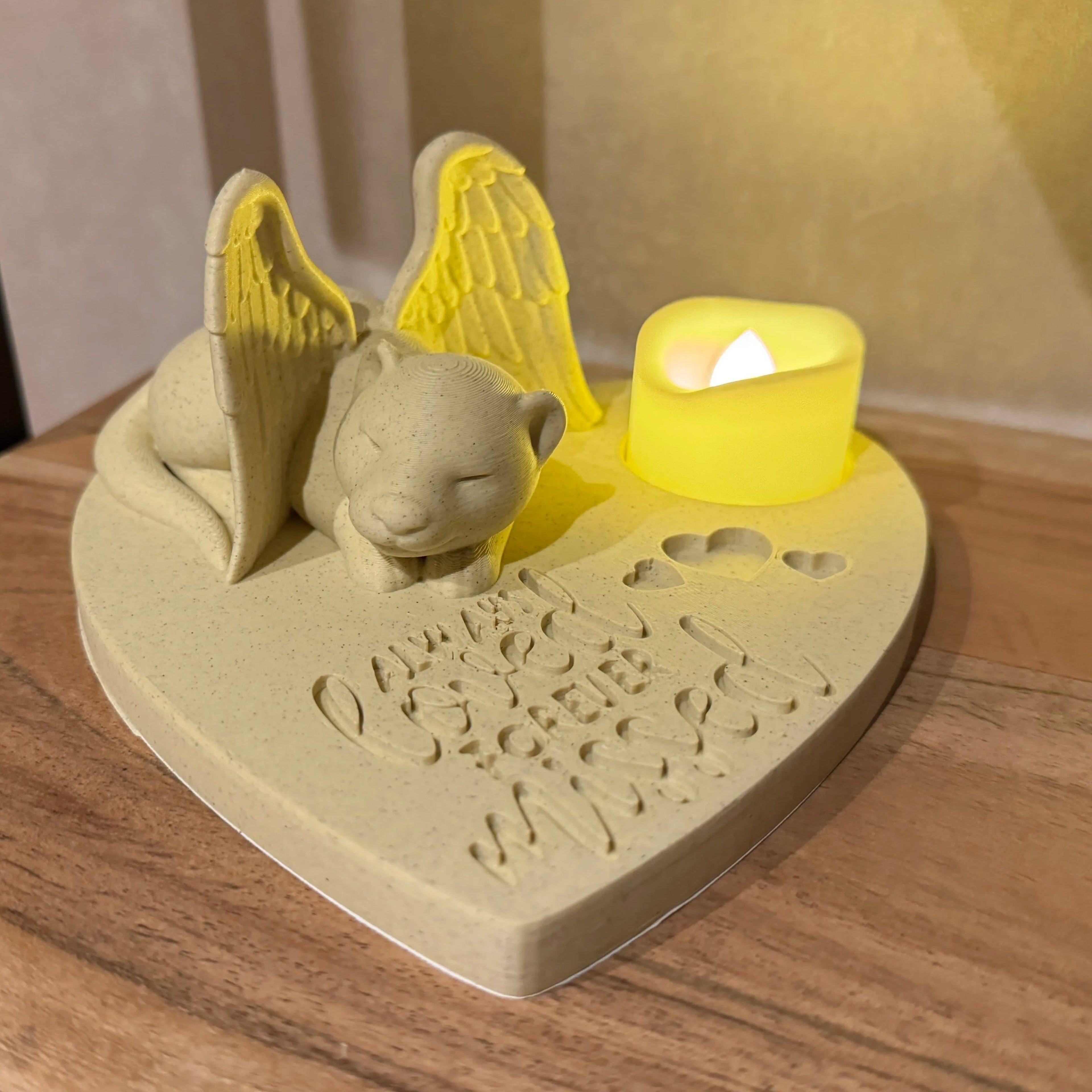 Decorative heart-shaped candle holder with a ferret with Angel wings on a wooden surface