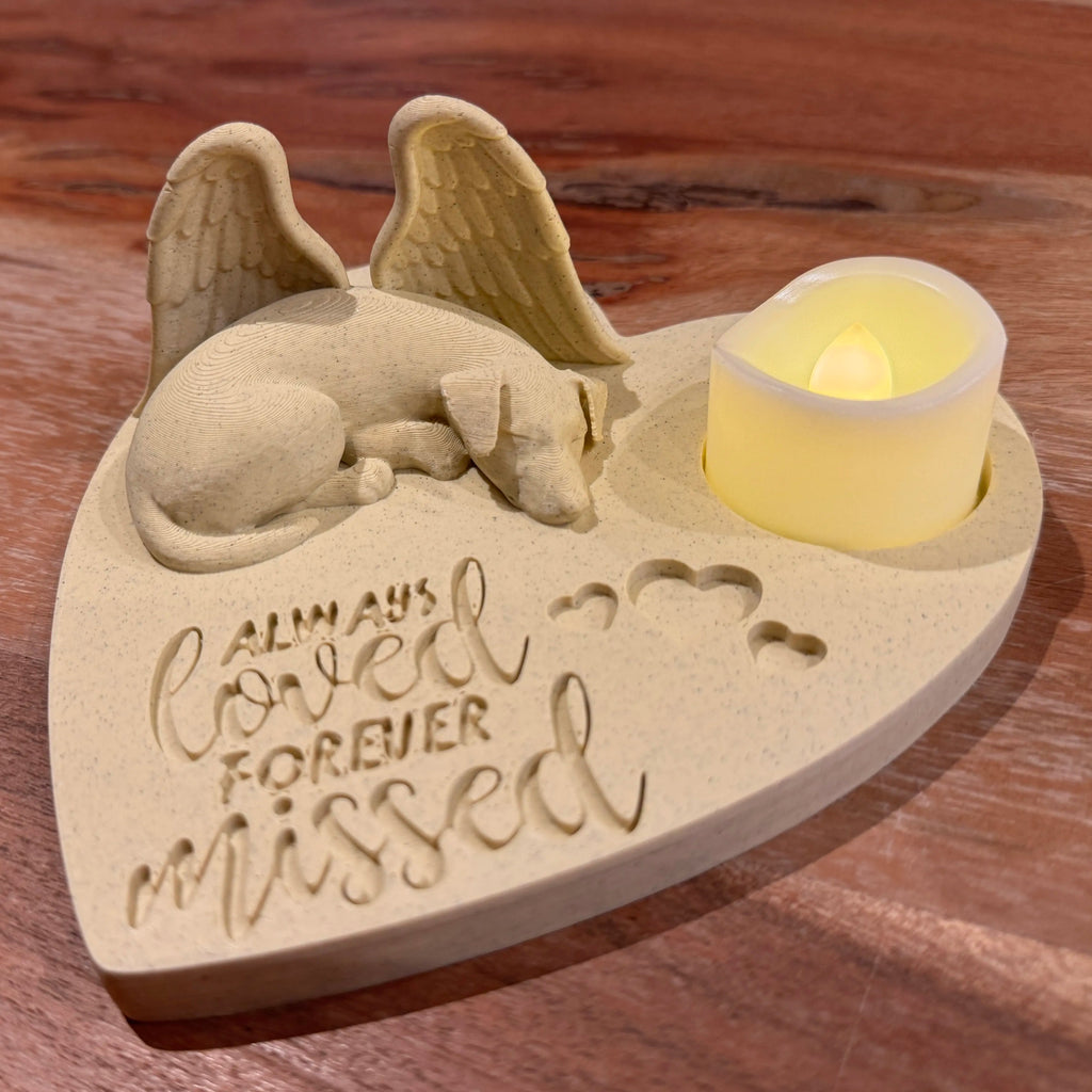Memorial ornament with a sleeping jack russell terrier with Angel wings, candle, and 'Always Loved Forever Missed' text on a wooden surface.