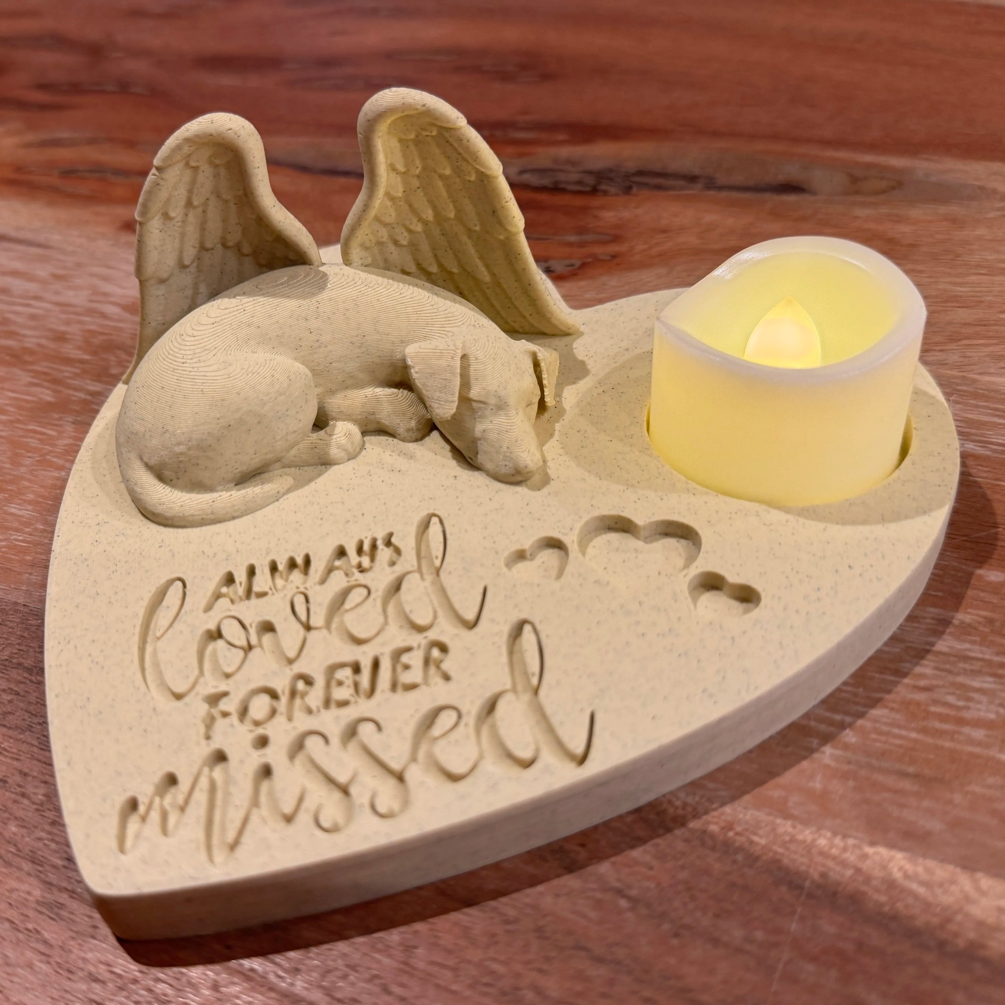 Memorial ornament with a sleeping jack russell terrier with Angel wings, candle, and 'Always Loved Forever Missed' text on a wooden surface.