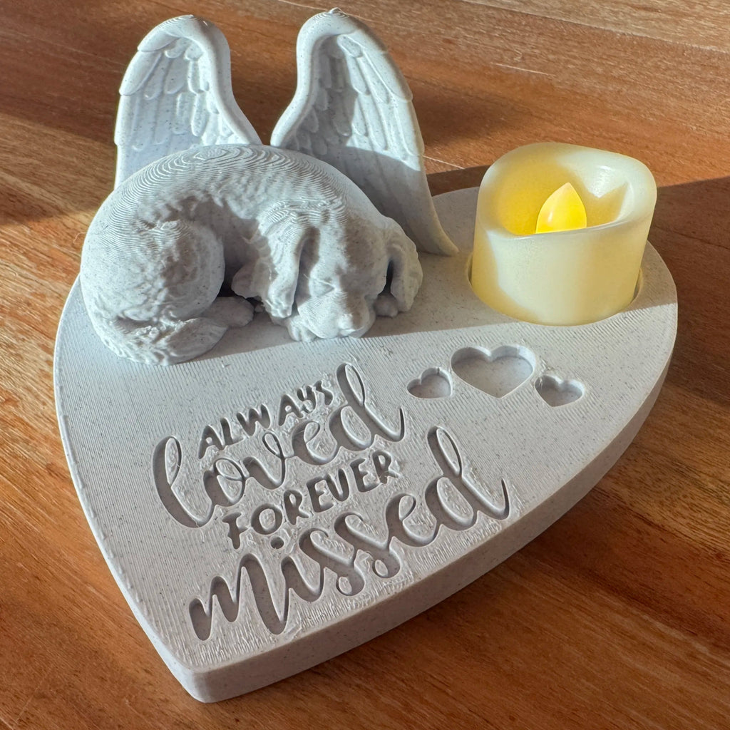 Memorial plaque with Cavalier King Charles Spaniel with Angel wings and candle on a wooden surface