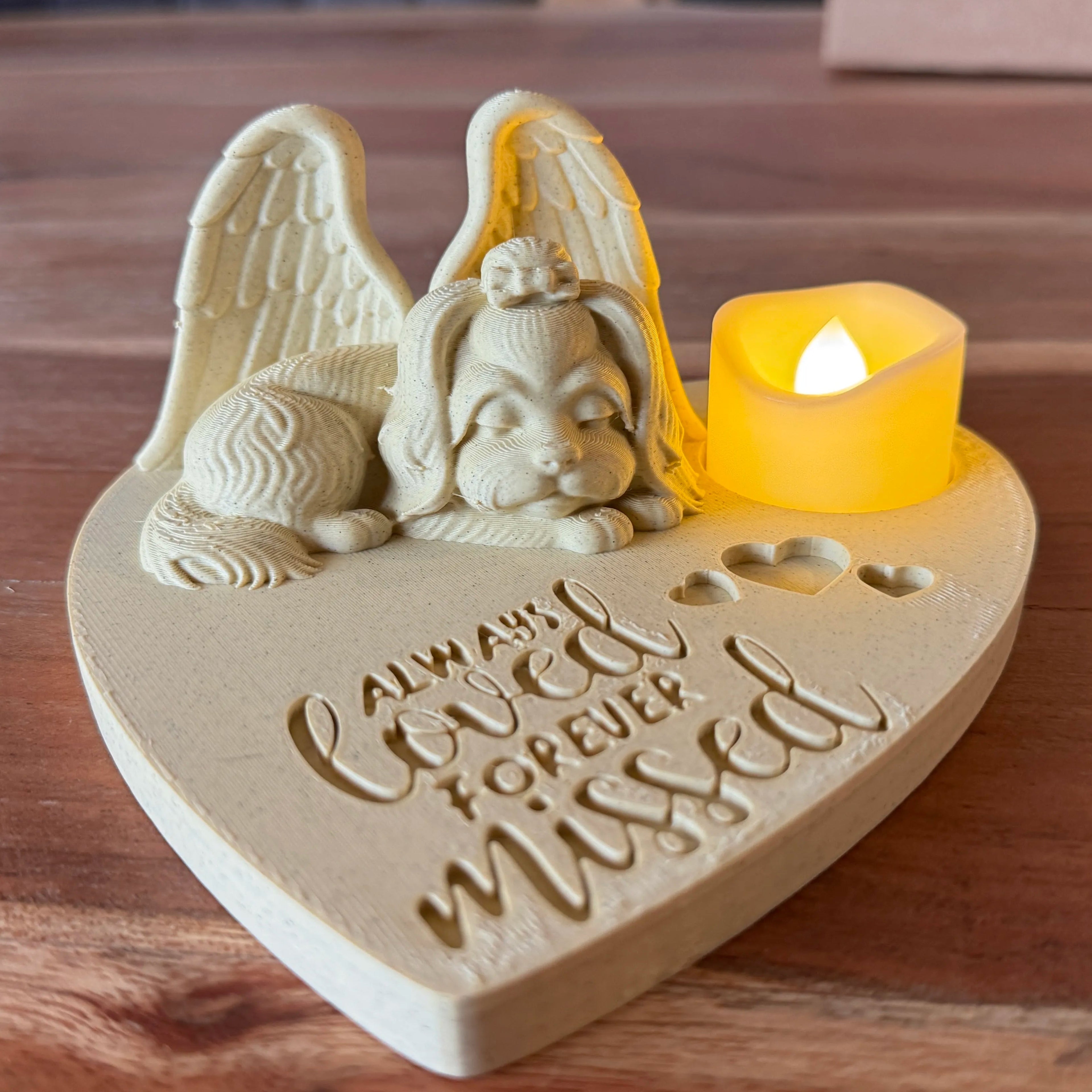 Memorial ornament with a Maltese with Angel wings and candle on a wooden surface