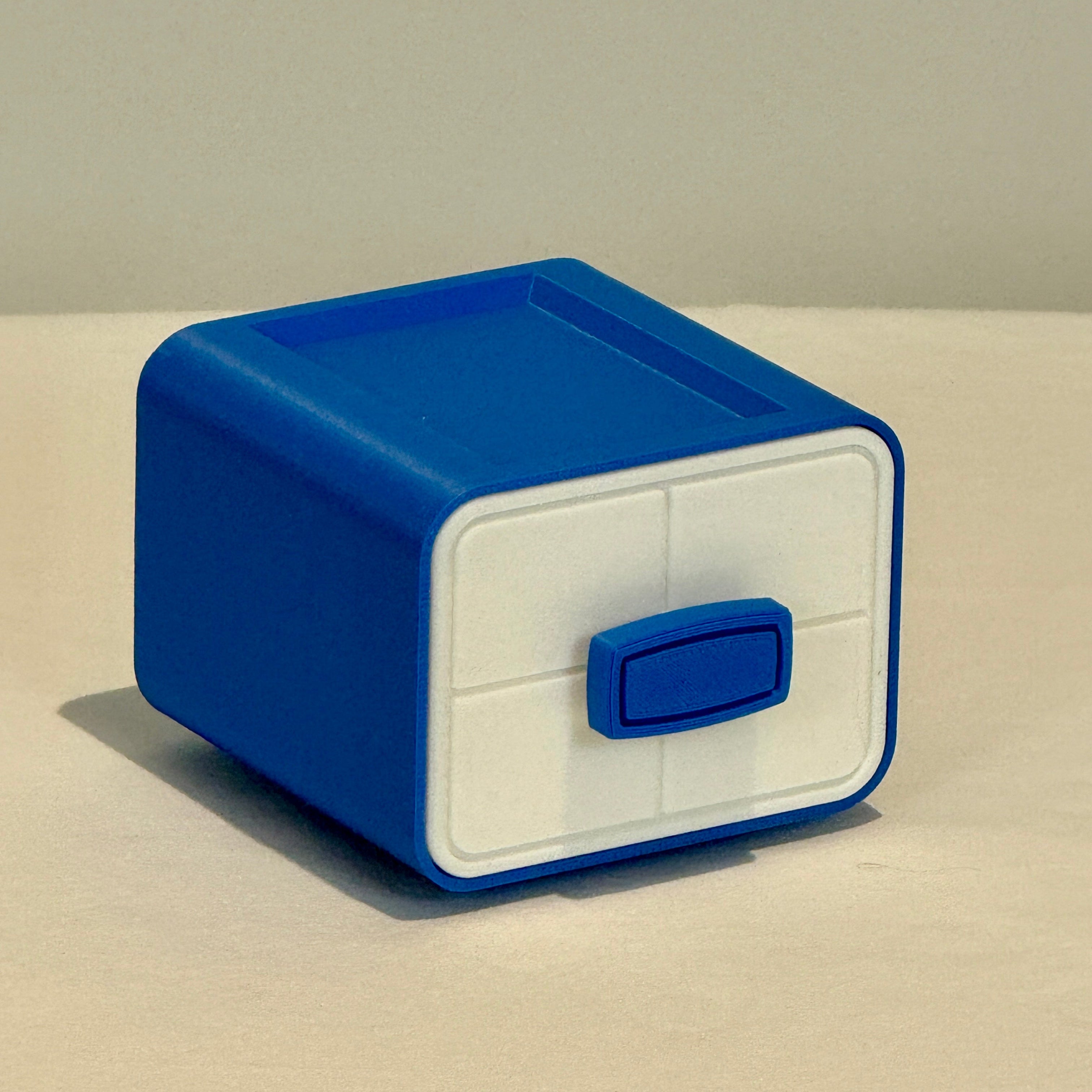 Blue and white storage box on a beige surface with a light gray background