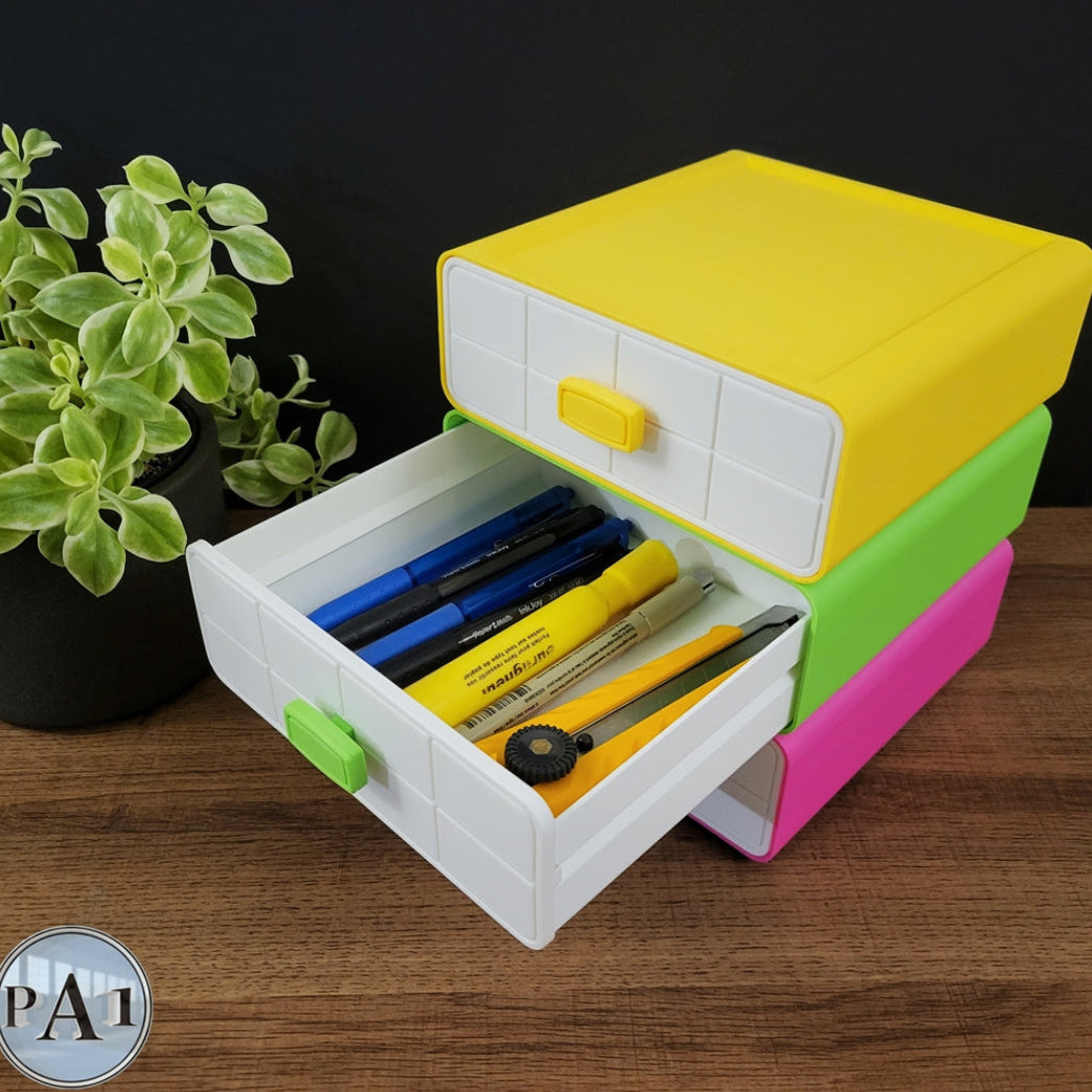Colorful toy toolbox with tools on a wooden surface next to a plant