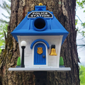 Birdhouse designed like a police station attached to a tree