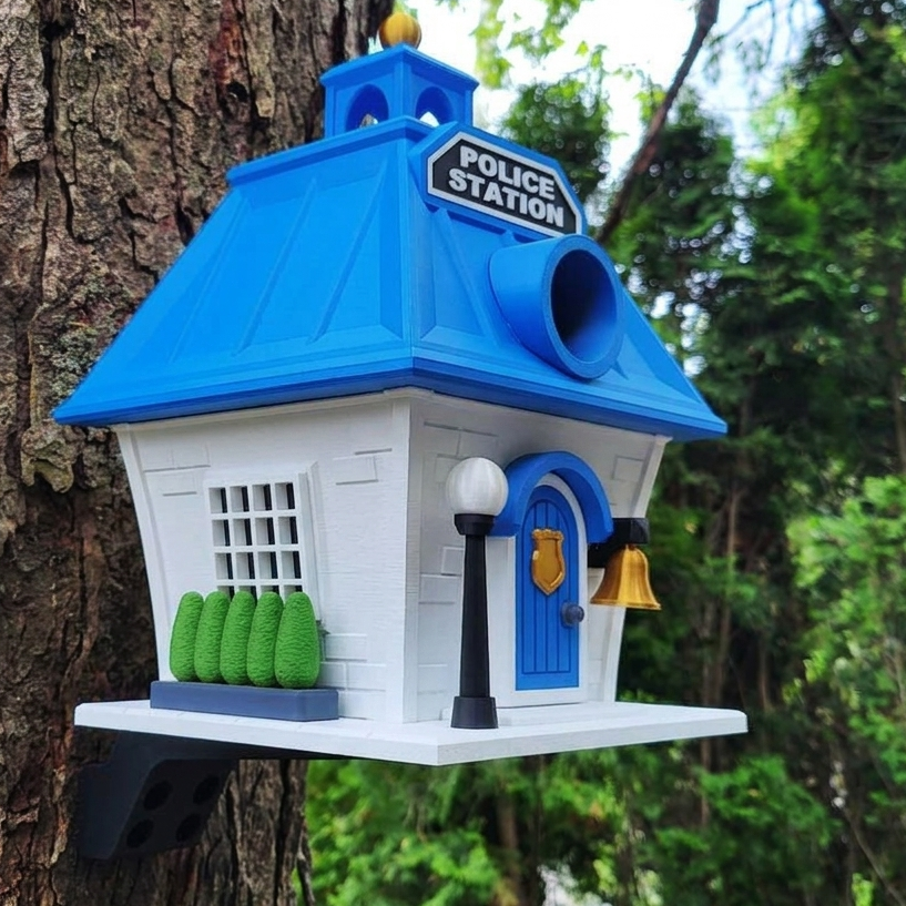 Birdhouse designed like a police station attached to a tree
